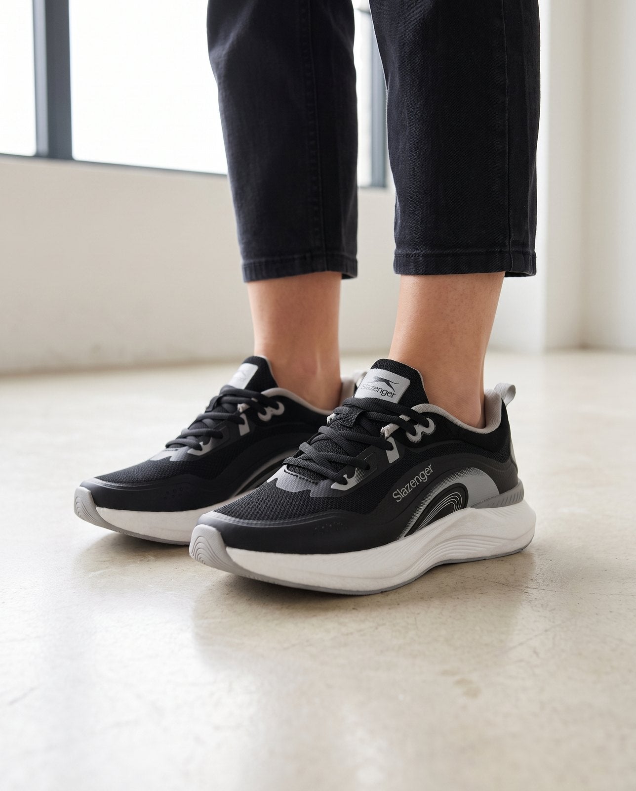 Close-up of the Slazenger Wera in black and white, standing on a stone floor